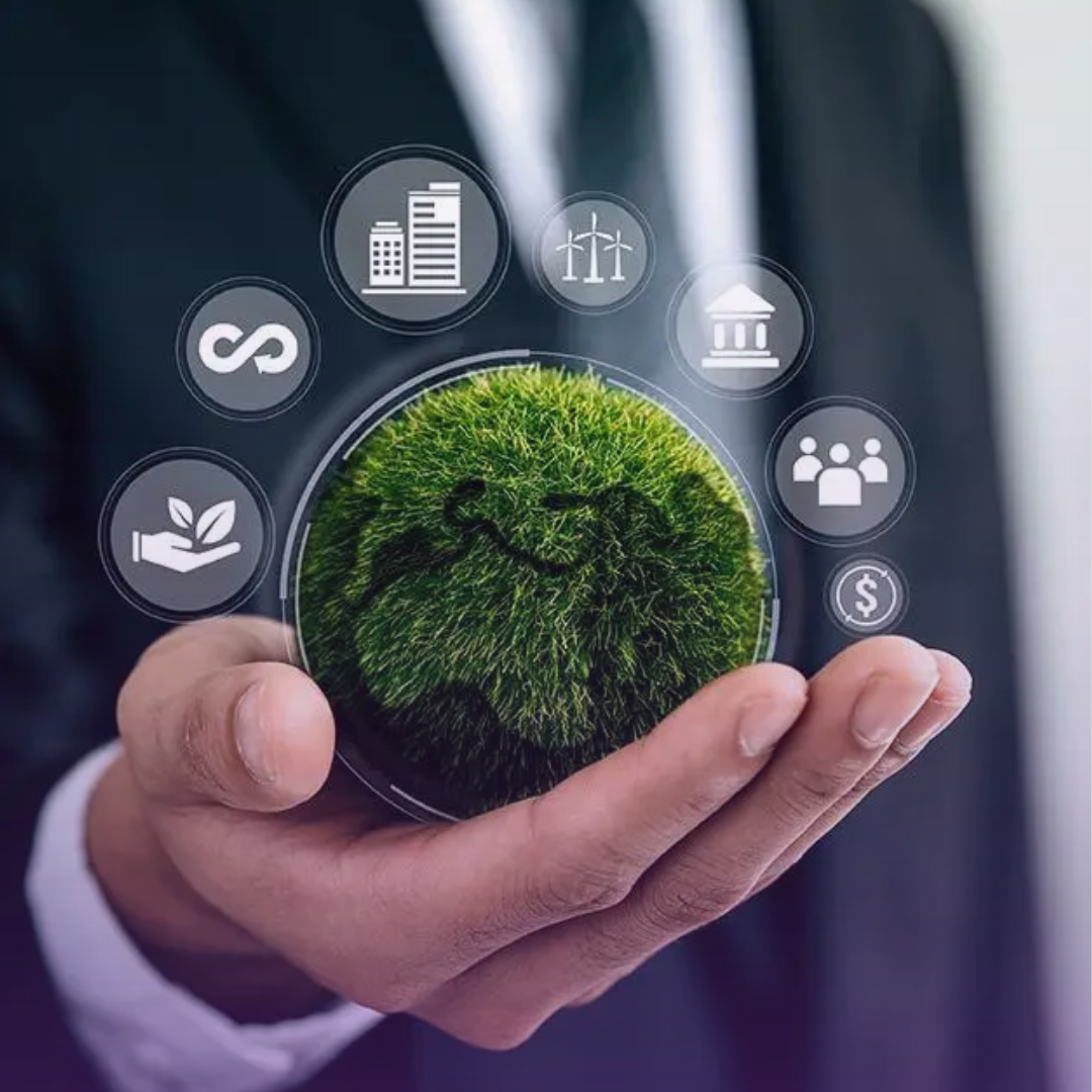 Under "A COMMITMENT TO SUSTAINABILITY": A hand in a business suit cradles a vibrant green, grassy globe in its palm, surrounded by holographic white icons representing various aspects of sustainability, including renewable energy, urban development, community, finance, and circular economy, symbolizing a holistic approach to corporate environmental responsibility.