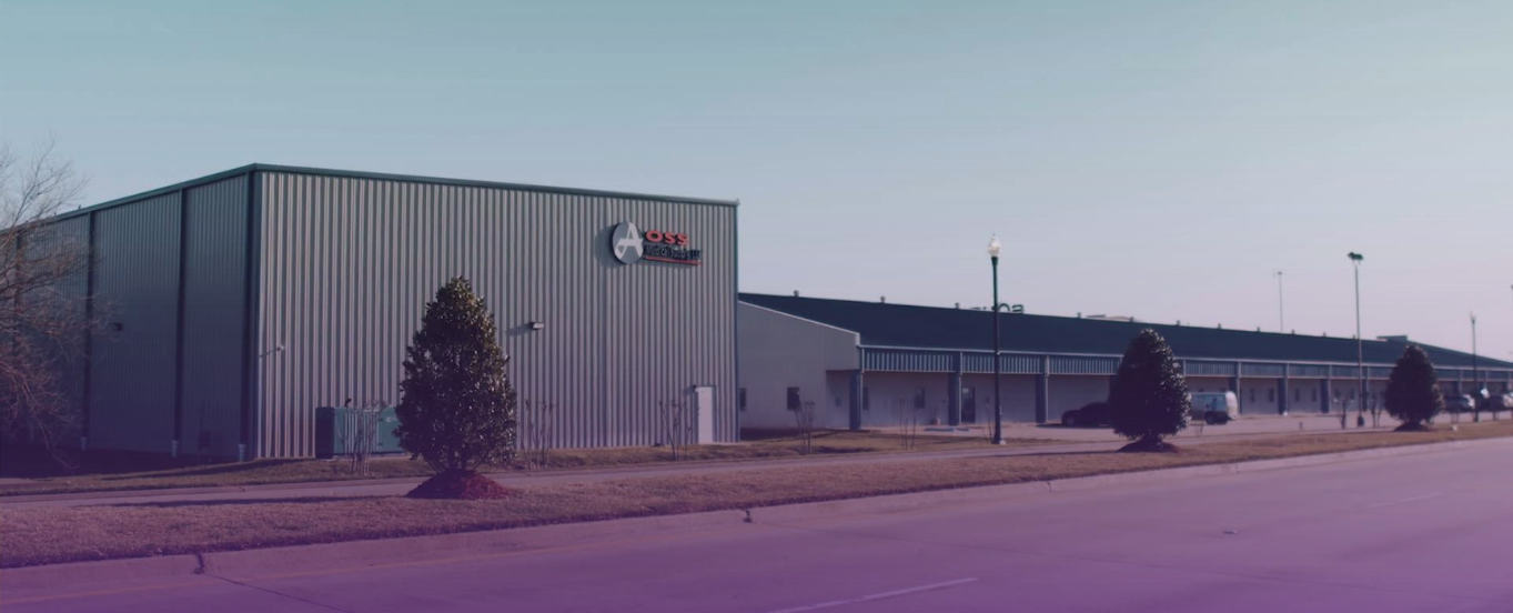 Expansive exterior of AOSS Medical Supply's industrial facility with logo, representing its established operational presence.