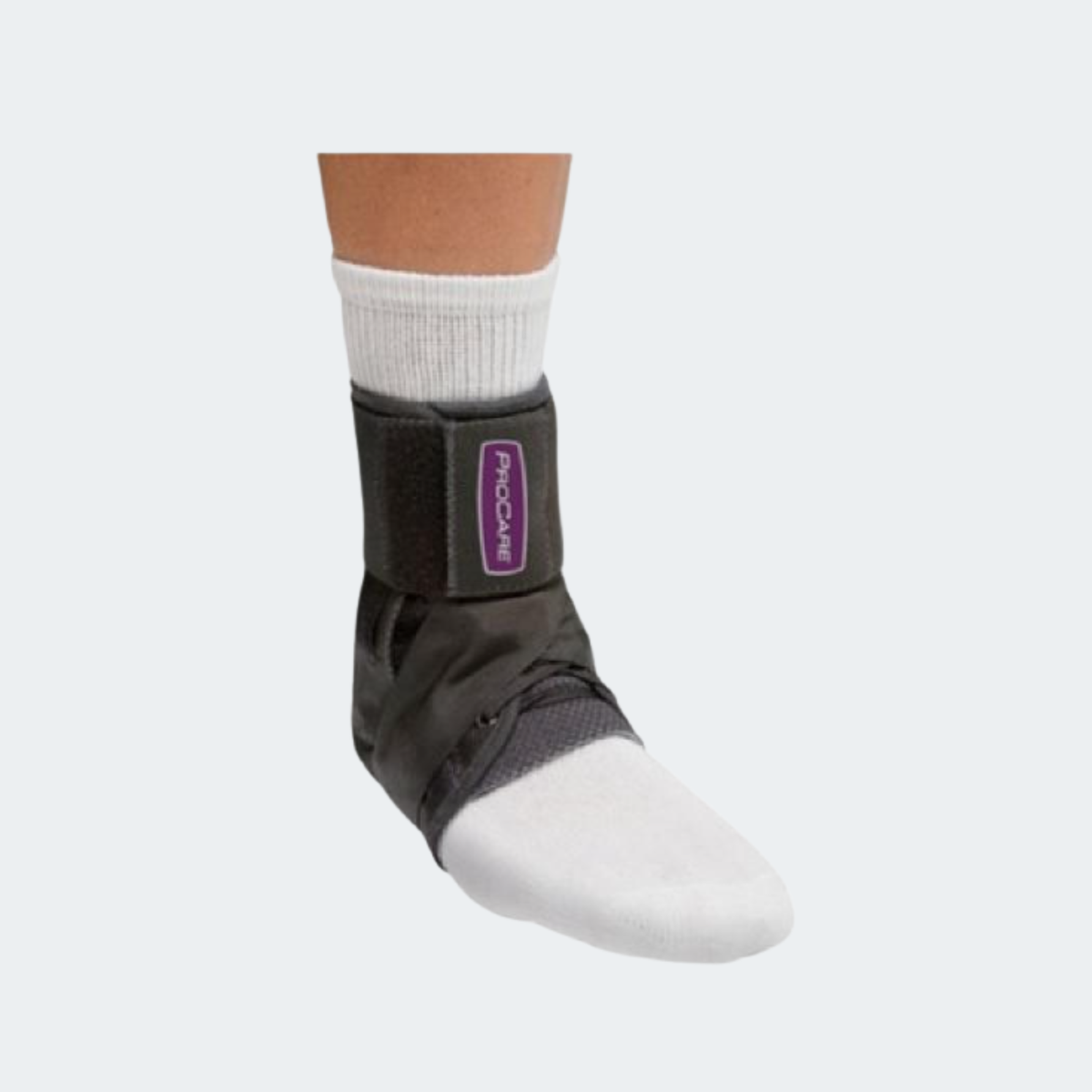 A black ankle support brace with a purple and white logo patch, shown on a person's foot wearing a white sock against a light gray background.