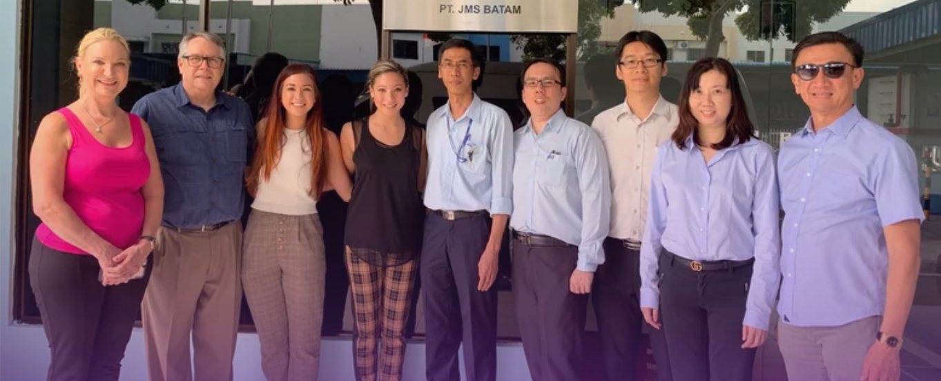 Cover photo for the AOSS Medical Supply 'Our Company/Founders' page: A diverse group of nine professionals, including the CEO, stand smiling together outside the 'PT. ALBADAR' building, representing the leadership and team behind AOSS Medical Supply.