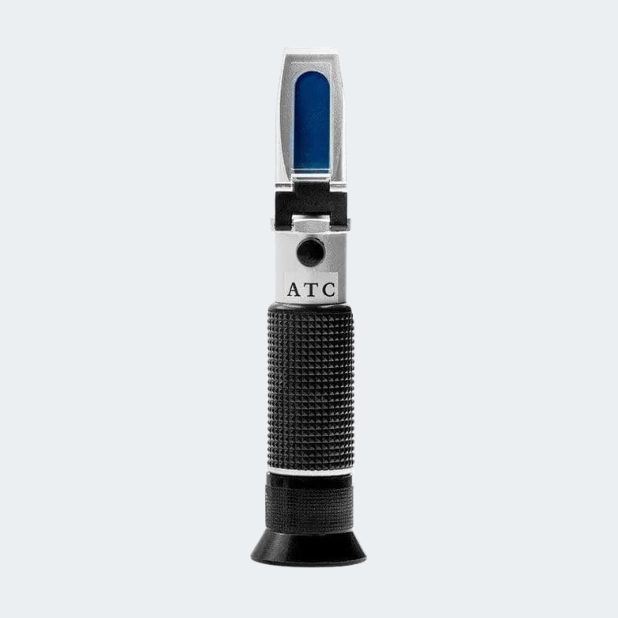 A handheld alcohol test thermometer with a textured black grip, silver metal body, and a blue-tinted viewing window, featuring the letters 'ATC' on the side, set against a solid light gray background.