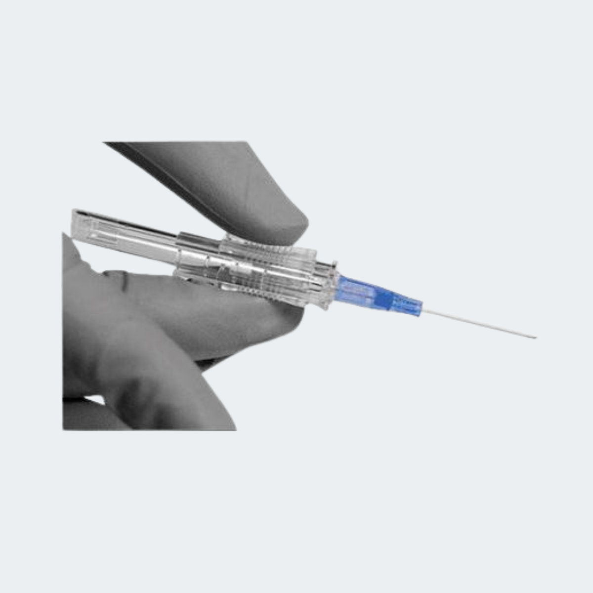 A hand holding a transparent syringe-style applicator with a blue plunger and a very fine needle tip, shown against a plain light gray background.