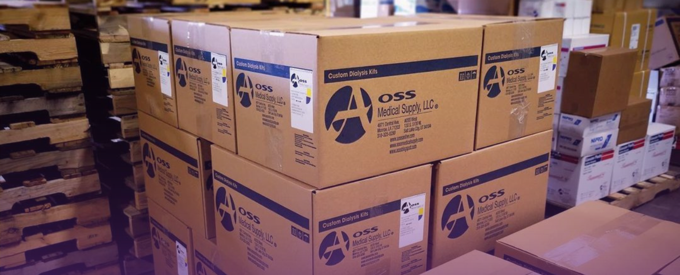 Banner for Logistics Expertise page: Stacks of brown shipping boxes labeled with the AOSS Medical Supply, LLC. logo, neatly arranged on pallets in a warehouse, representing organized medical supply logistics.
